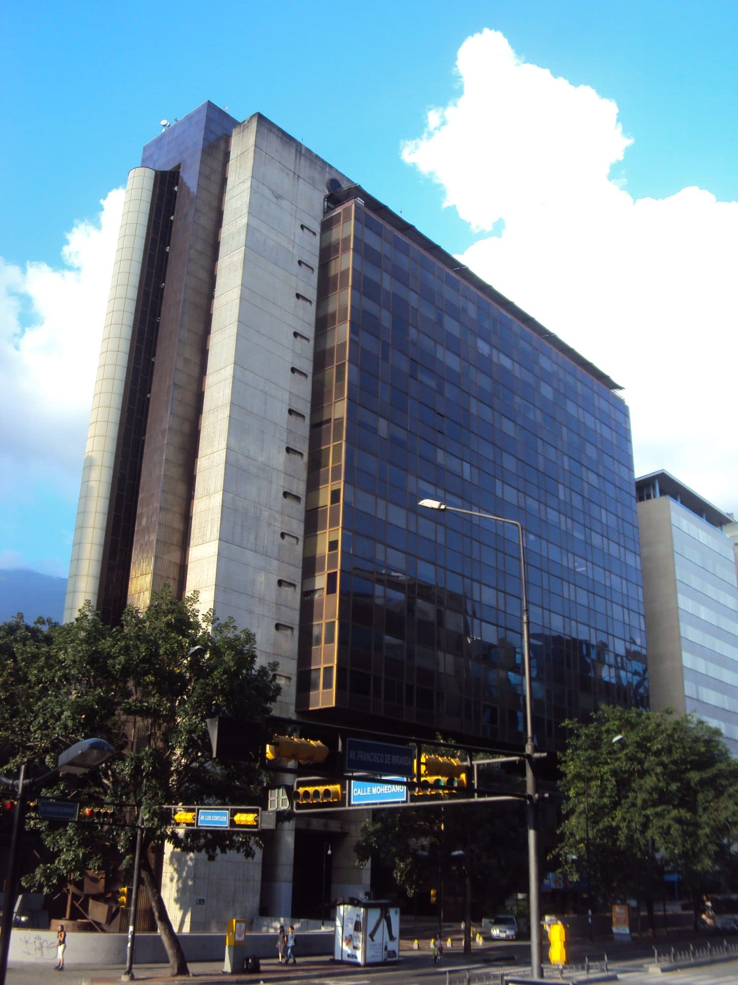 Torre Europa in Chacao, Caracas, seen from the corner of Avenida Francisco de Miranda, with a concrete shaft beside a dark glass volume