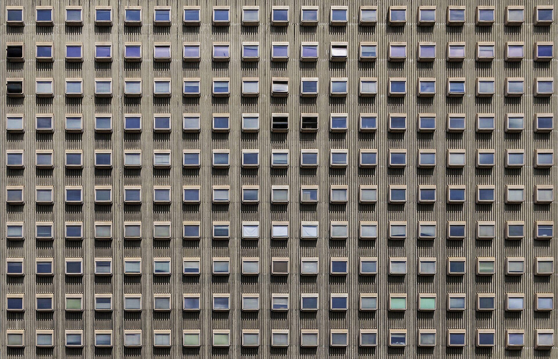 Concrete facade of Torre América in Bello Monte, Caracas, with a regular grid of recessed windows