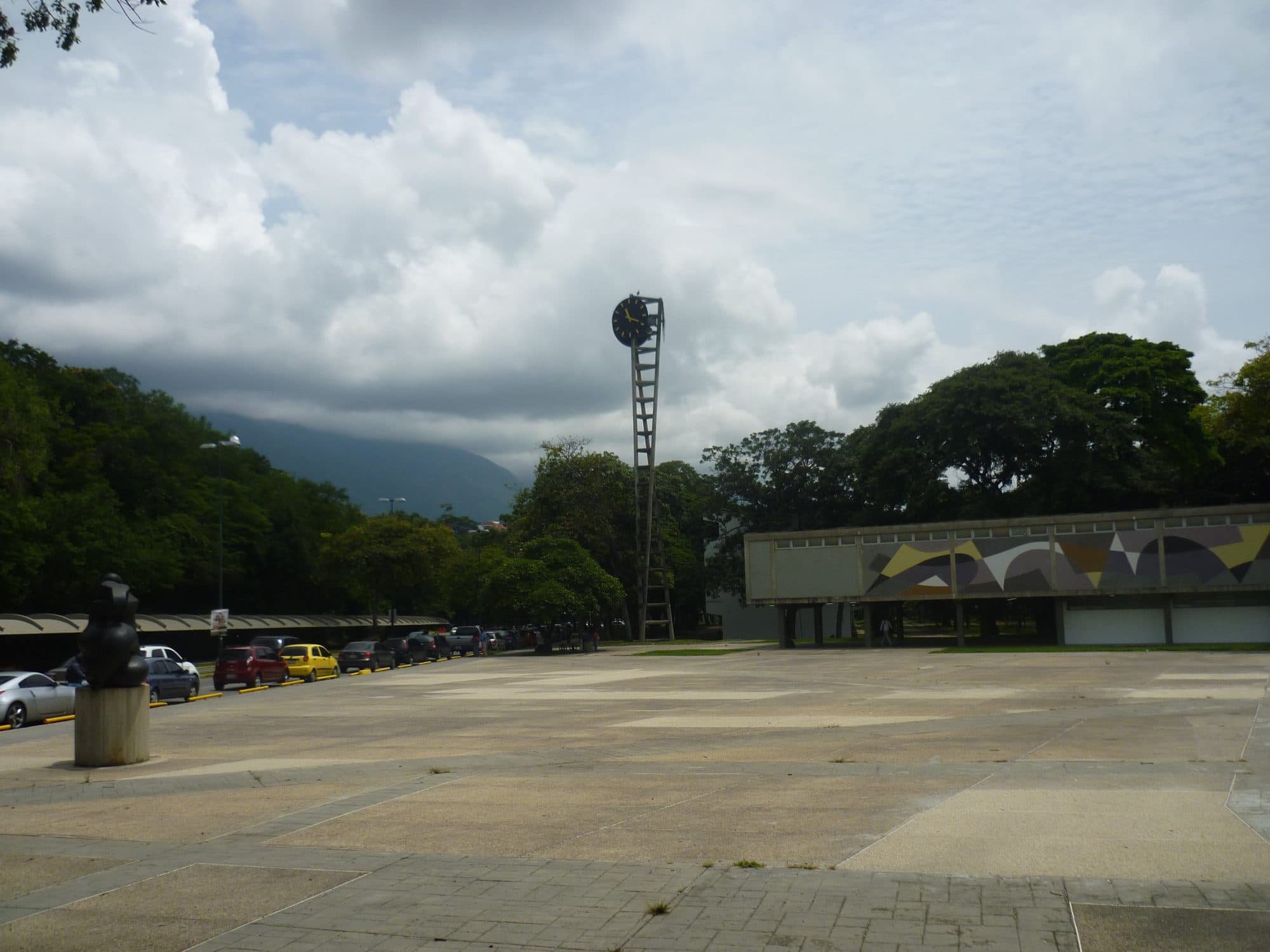 Plaza del Rectorado at the Ciudad Universitaria, with the clock tower and a low building carrying a mural