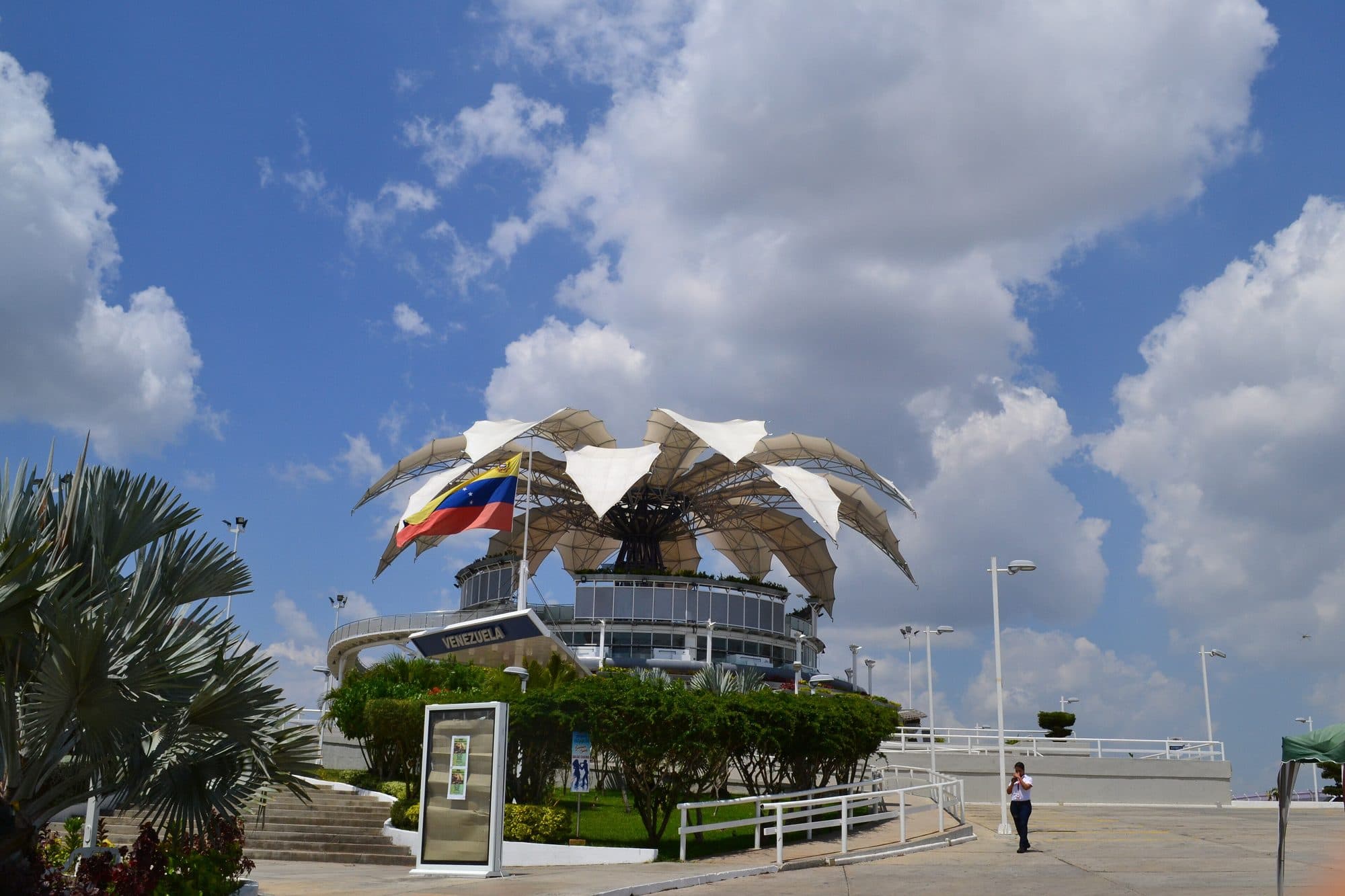 Flower-shaped steel and fabric canopy of the Flor de Venezuela in Barquisimeto under a cloudy blue sky