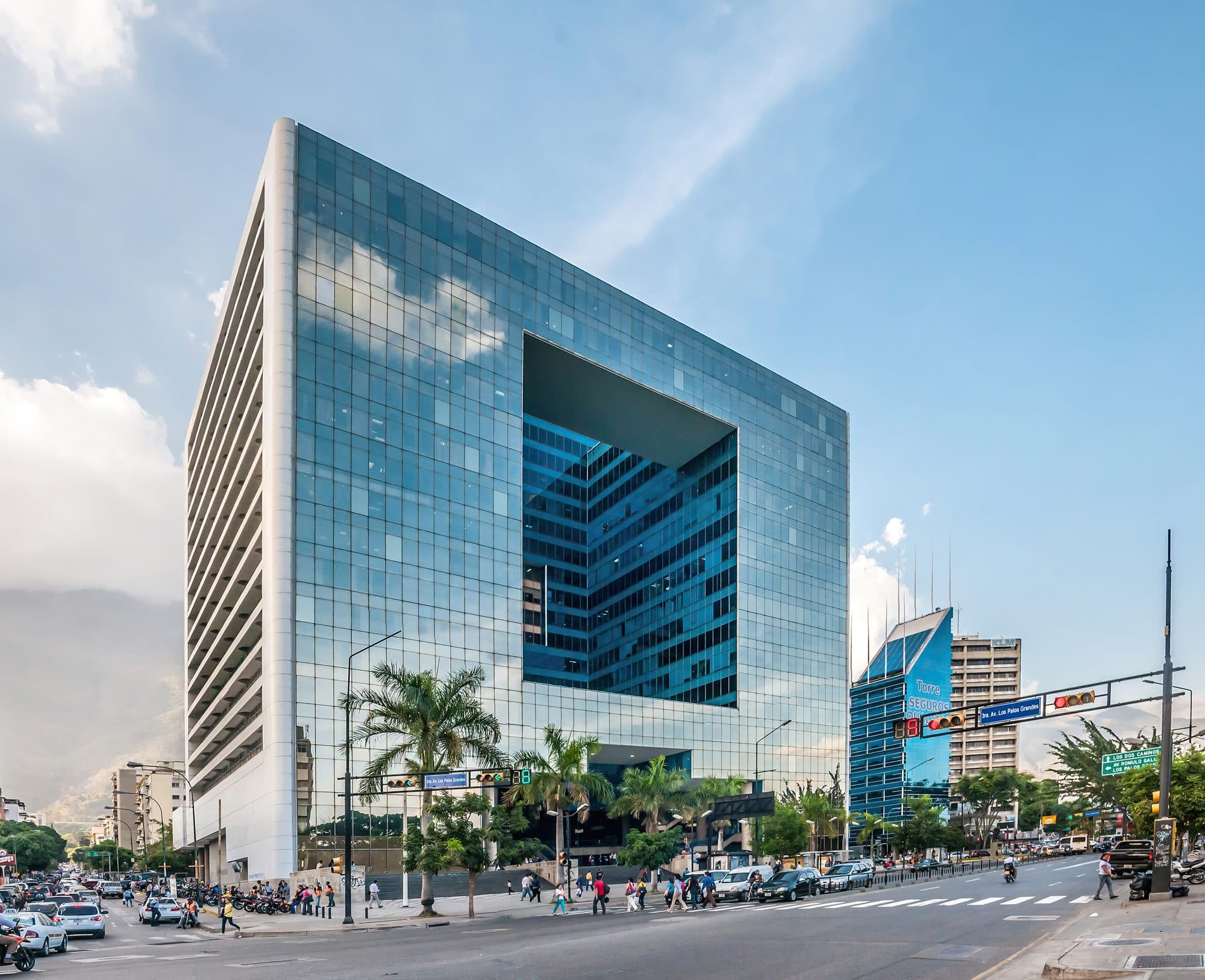 The glass-faced Parque Cristal office building in Caracas seen from a street corner