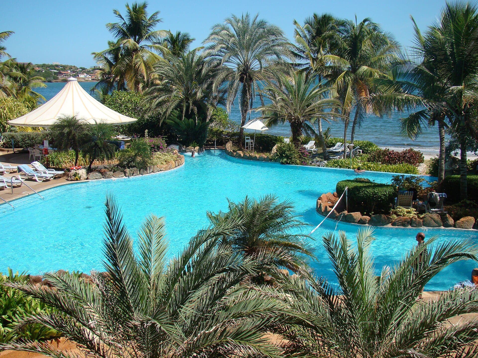 Swimming pool, palm trees and bay at the Hilton hotel on Margarita Island