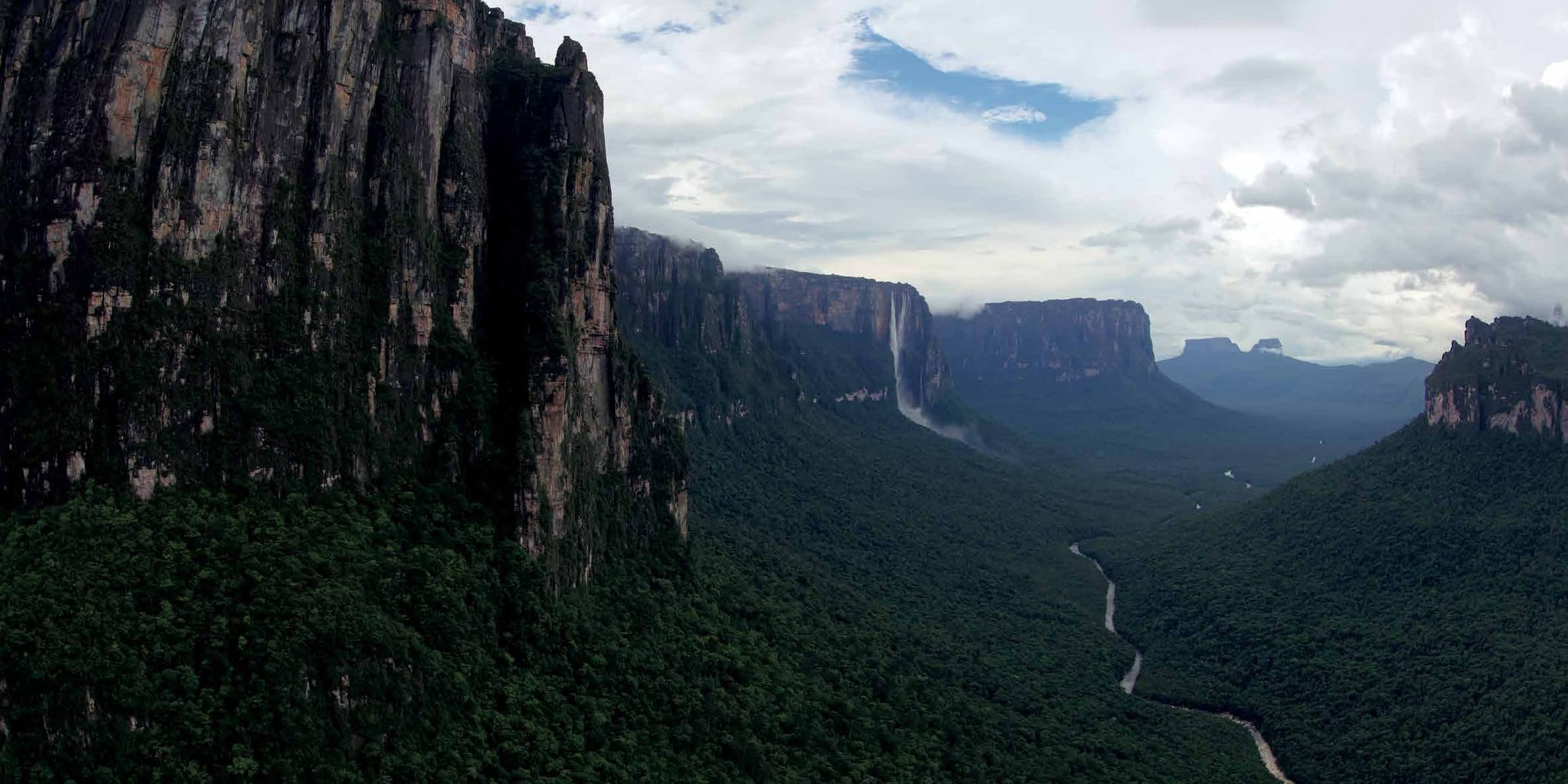 A river valley beneath towering tepui cliffs